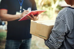 Customer signing for a parcel on a clipboard