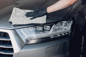 Man polishing a car in a garage