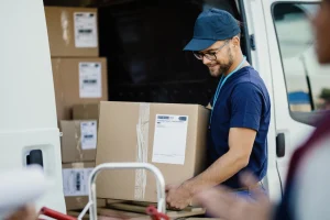 Delivery worker unloading parcels from a van