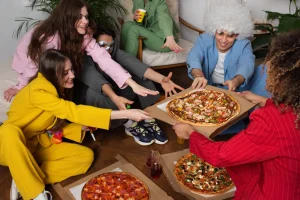 Young people at a costume party with food